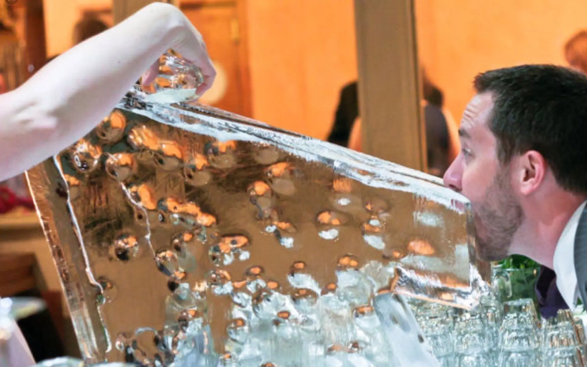 Guest drinking from an AAA ICE luge at an event