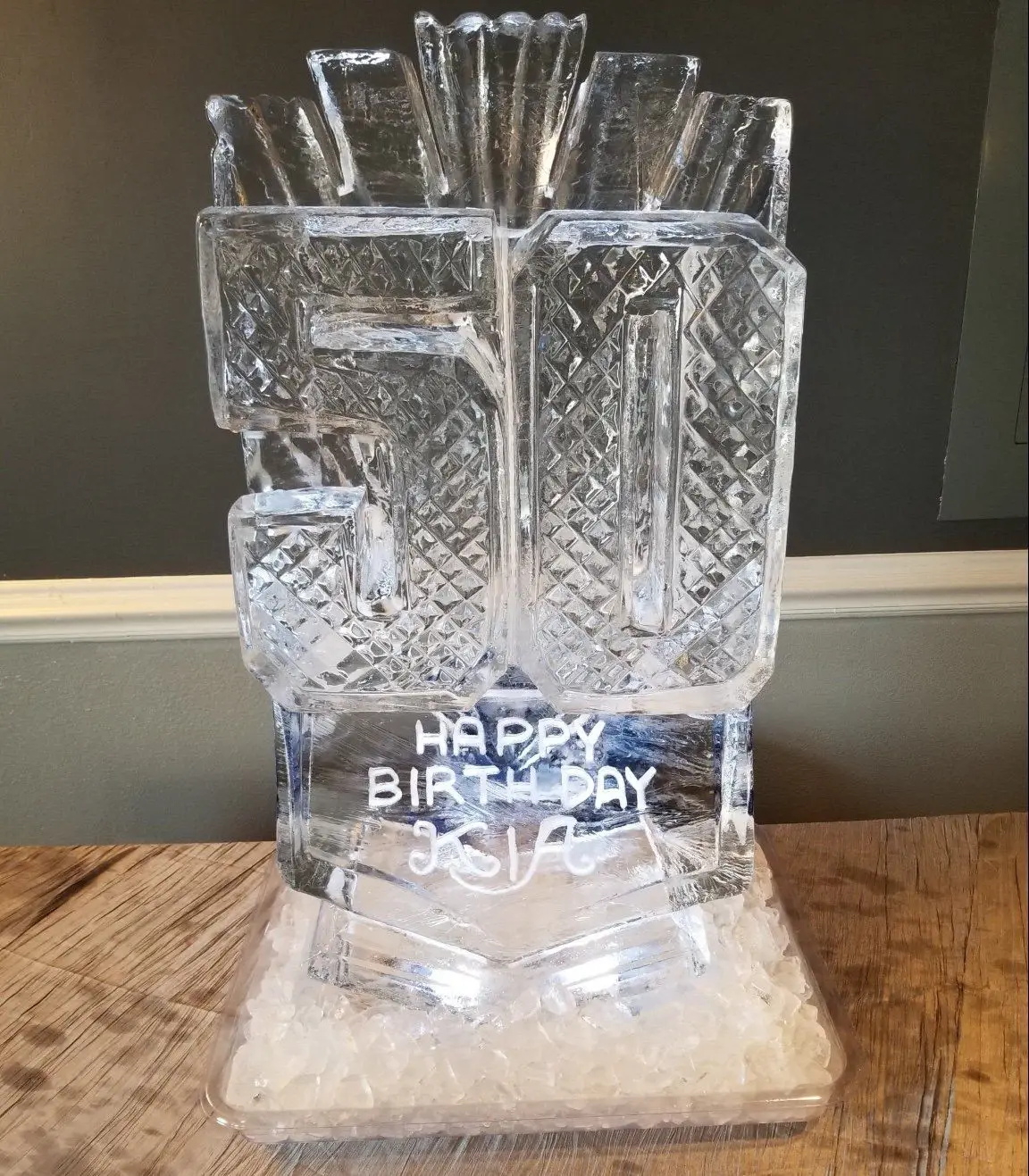 Carved 50 ice sculpture reading Happy Birthday